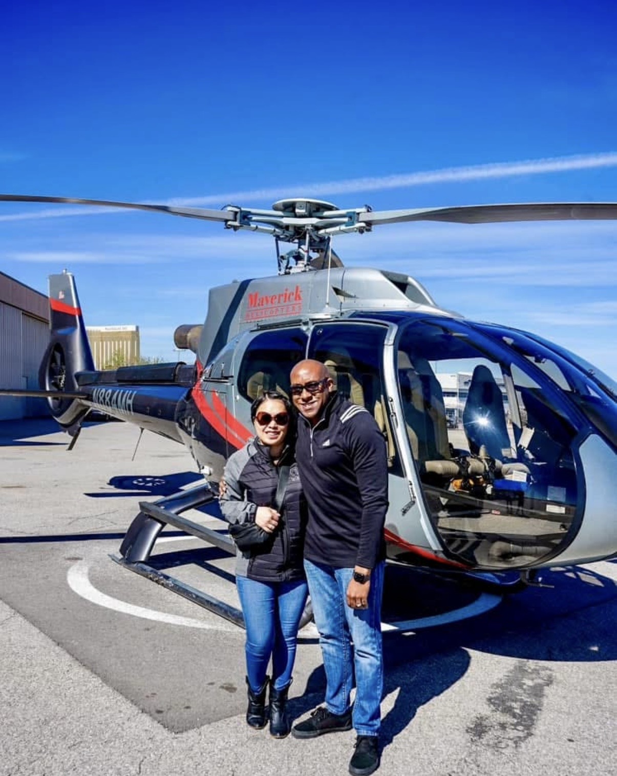 Dr. King and V. King beside a helicopter