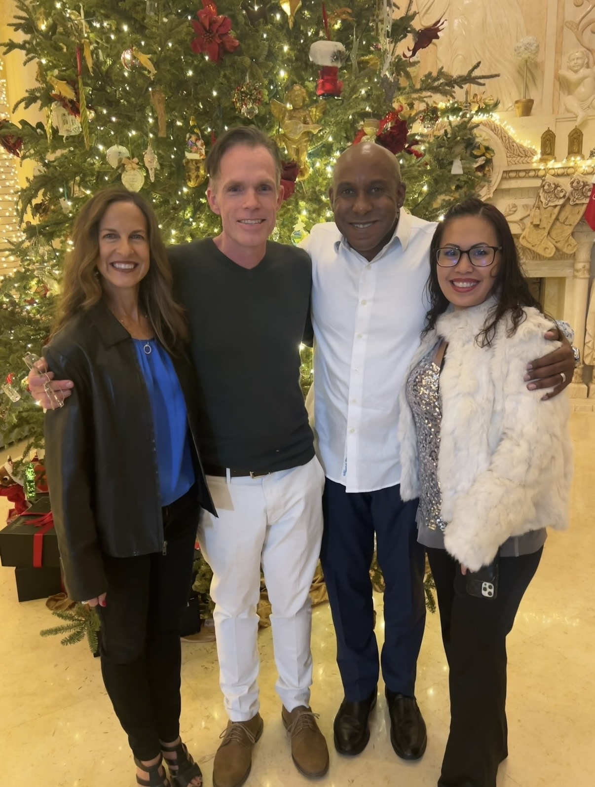 Dr. King and V. King celebrating Christmas with attorney Eric Barker at Mark Nejame's Christmas party