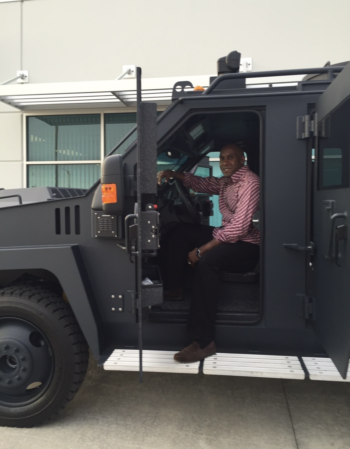 Dr. Dexter King behind the wheel of an Orlando Police Department armored vehicle